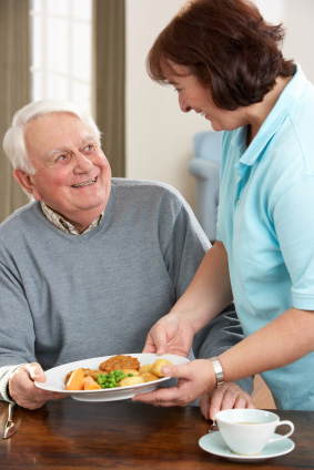 Staff delivering meal to man